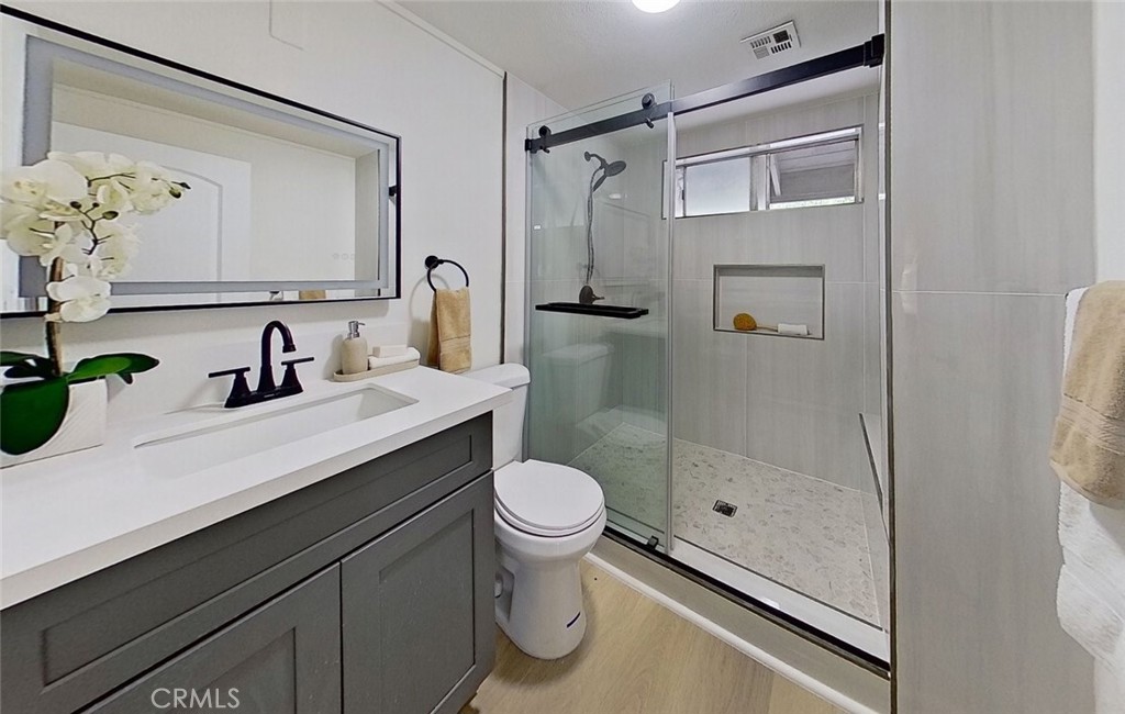 2390 Prenda Avenue Riverside, CA 92504 - Photo 13 of 21 a bathroom with a sink a toilet and shower