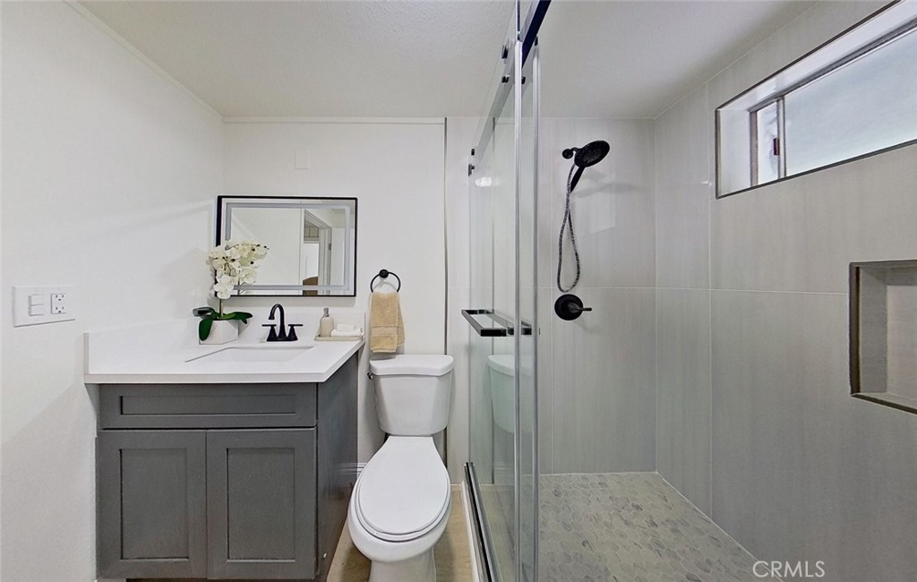 2390 Prenda Avenue Riverside, CA 92504 - Photo 14 of 21 a bathroom with a toilet sink vanity granite and shower