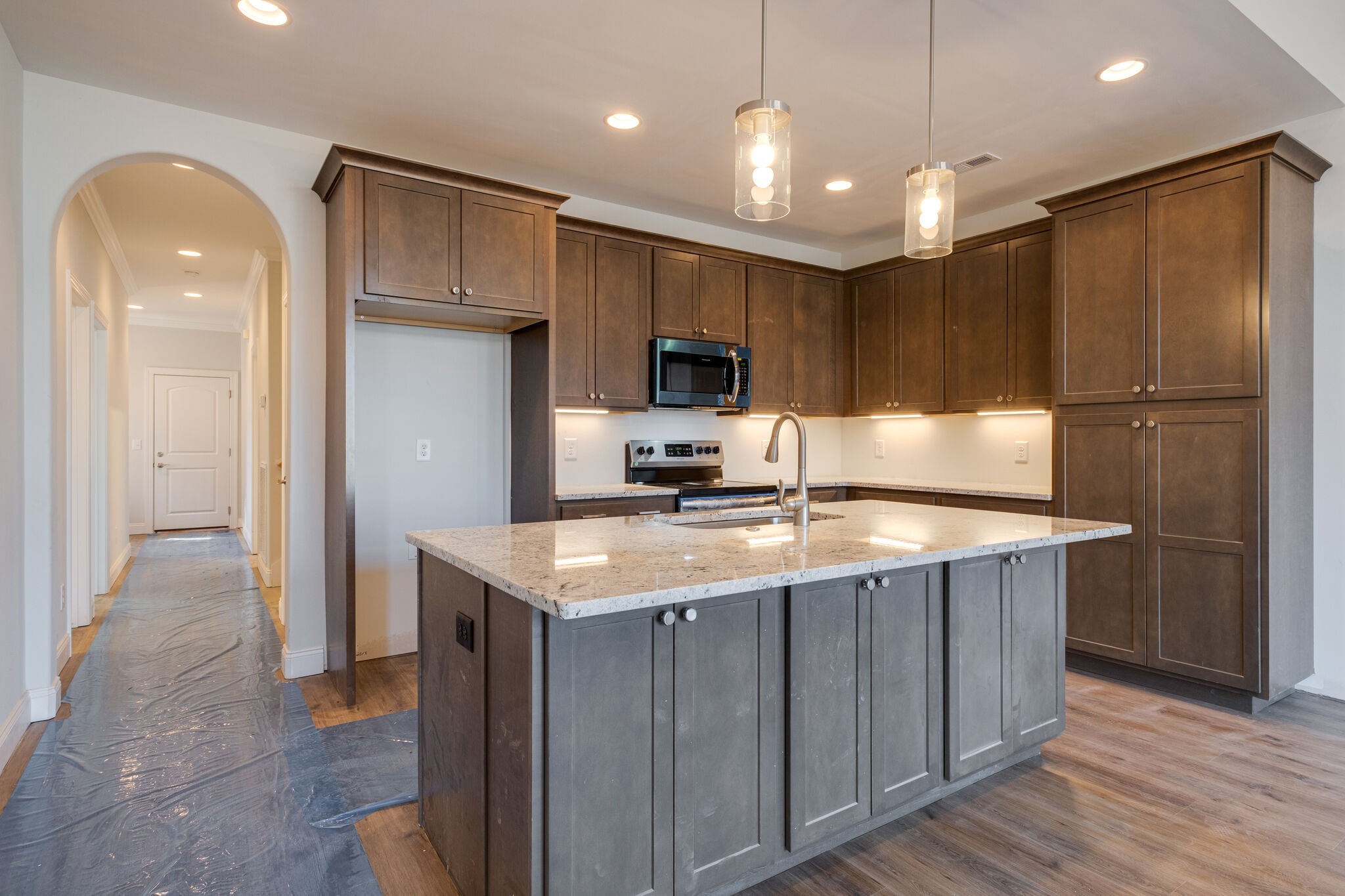 7 The Greens Springfield, TN 37172 - Photo 8 of 29 a kitchen with kitchen island granite countertop stainless steel appliances cabinets a sink and a counter top space