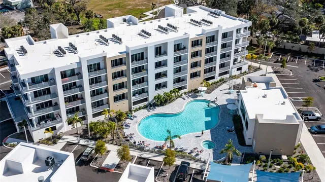 a view of swimming pool with outdoor seating and plants
