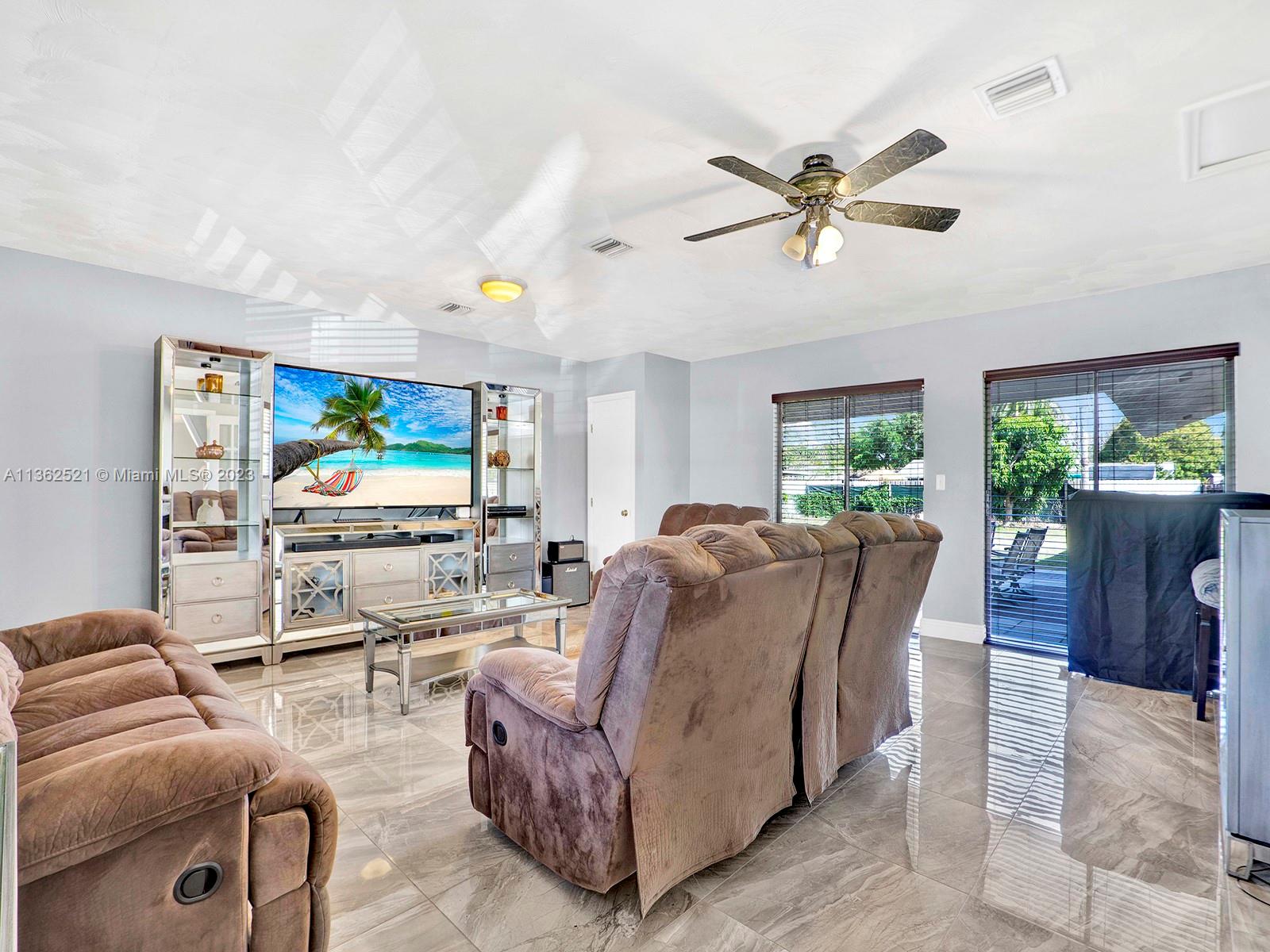 131 Northeast 17th Street Homestead, FL 33030 - Photo 11 of 24 a living room with furniture and a flat screen tv