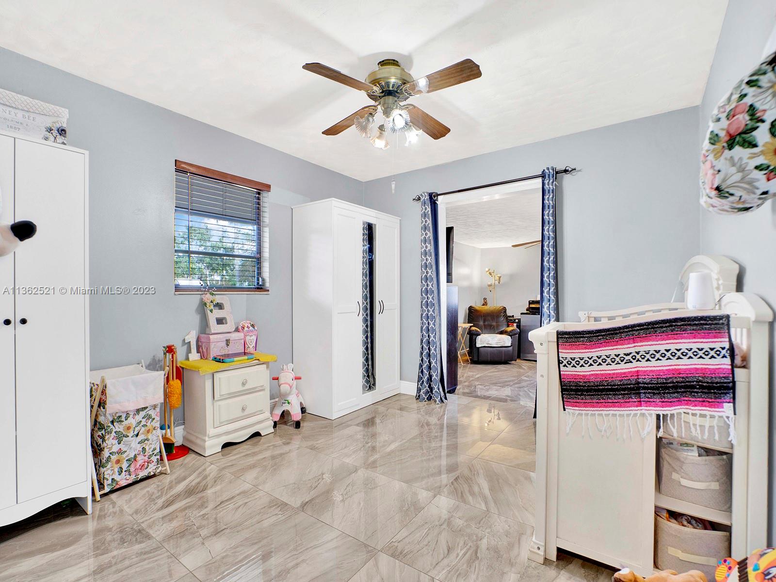 131 Northeast 17th Street Homestead, FL 33030 - Photo 13 of 24 a bedroom with furniture and a gym equipment
