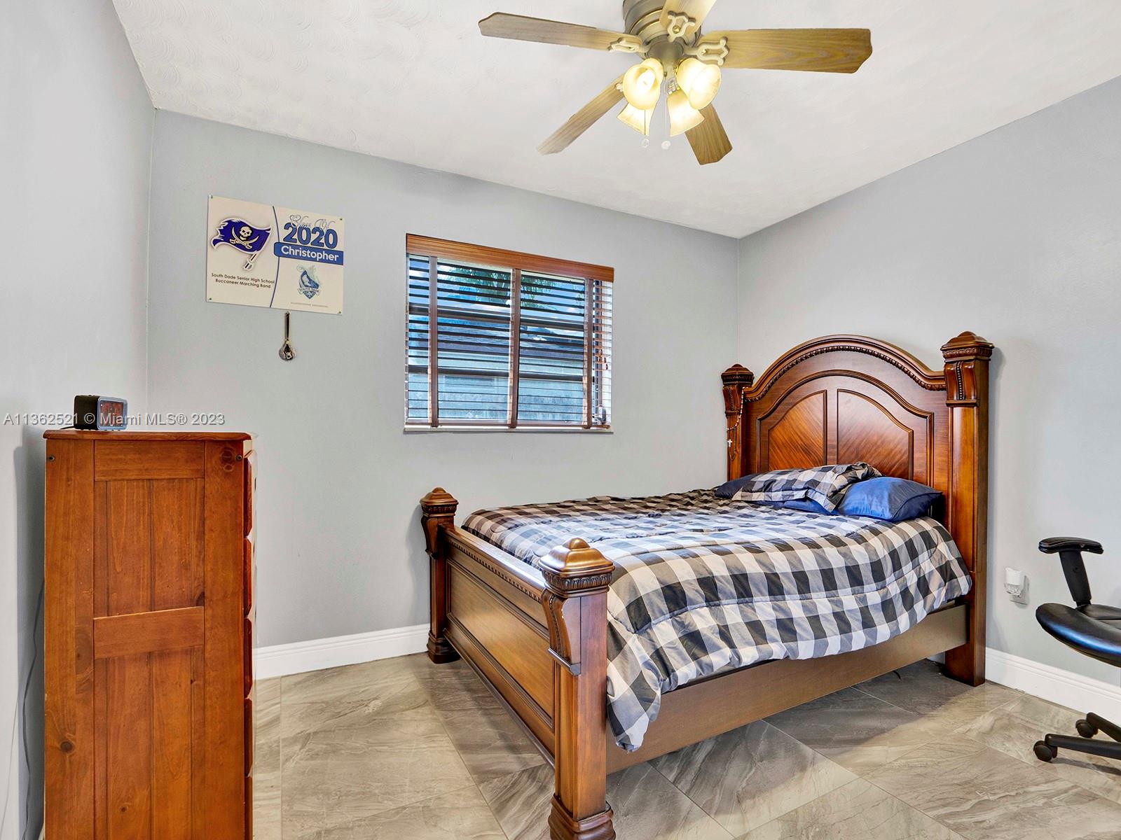 131 Northeast 17th Street Homestead, FL 33030 - Photo 17 of 24 a bedroom with a bed and a dresser