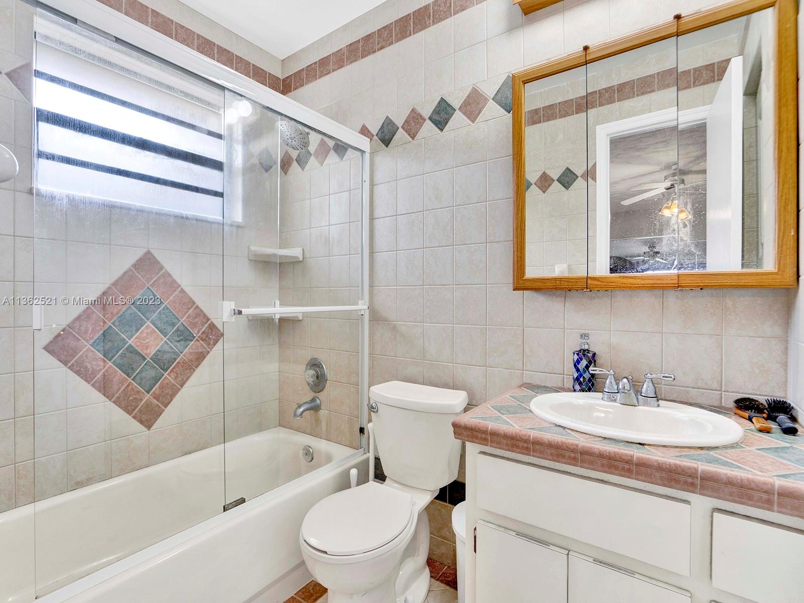 131 Northeast 17th Street Homestead, FL 33030 - Photo 18 of 24 a bathroom with a sink toilet and shower