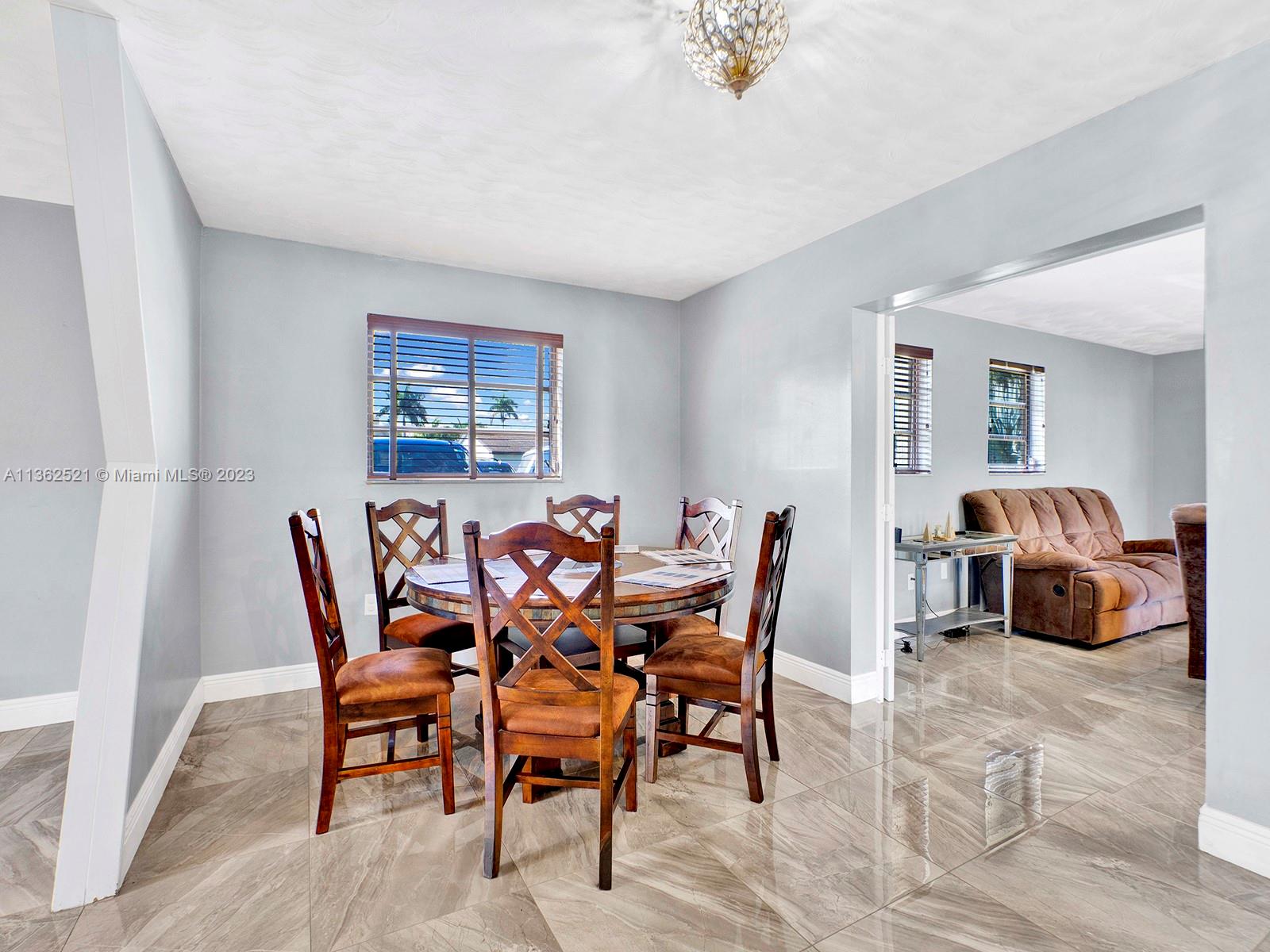 131 Northeast 17th Street Homestead, FL 33030 - Photo 9 of 24 a view of a dining room that has a table and chairs in it