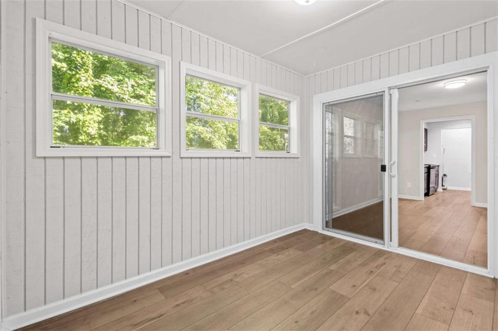 1166 Booth Road, Unit 407 Marietta, GA 30008 - Photo 9 of 18 an empty room with wooden floor and windows