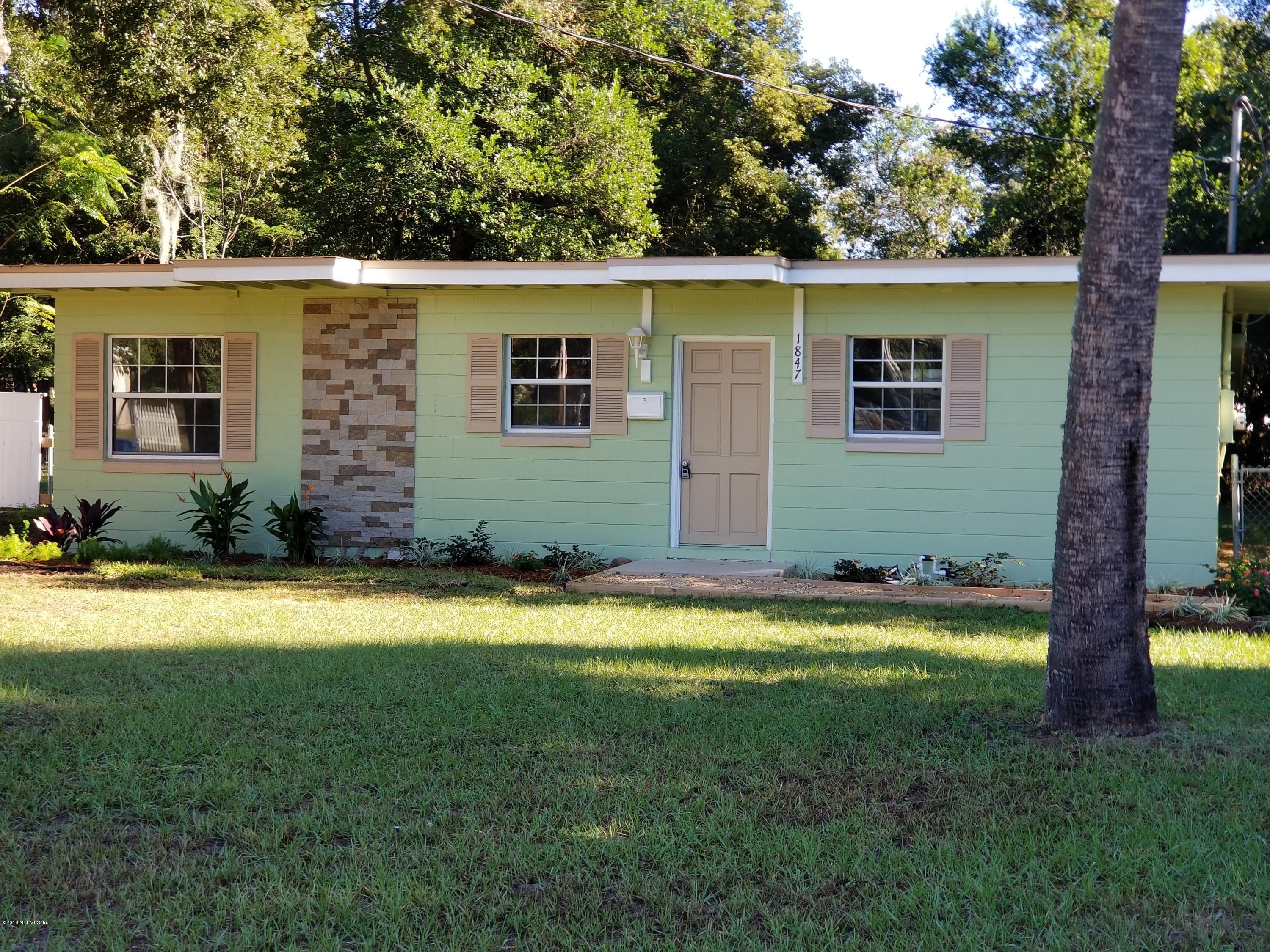 1847 Griflet Road Jacksonville, FL 32211 - Photo 1 of 32 a view of a backyard with plants and large tree