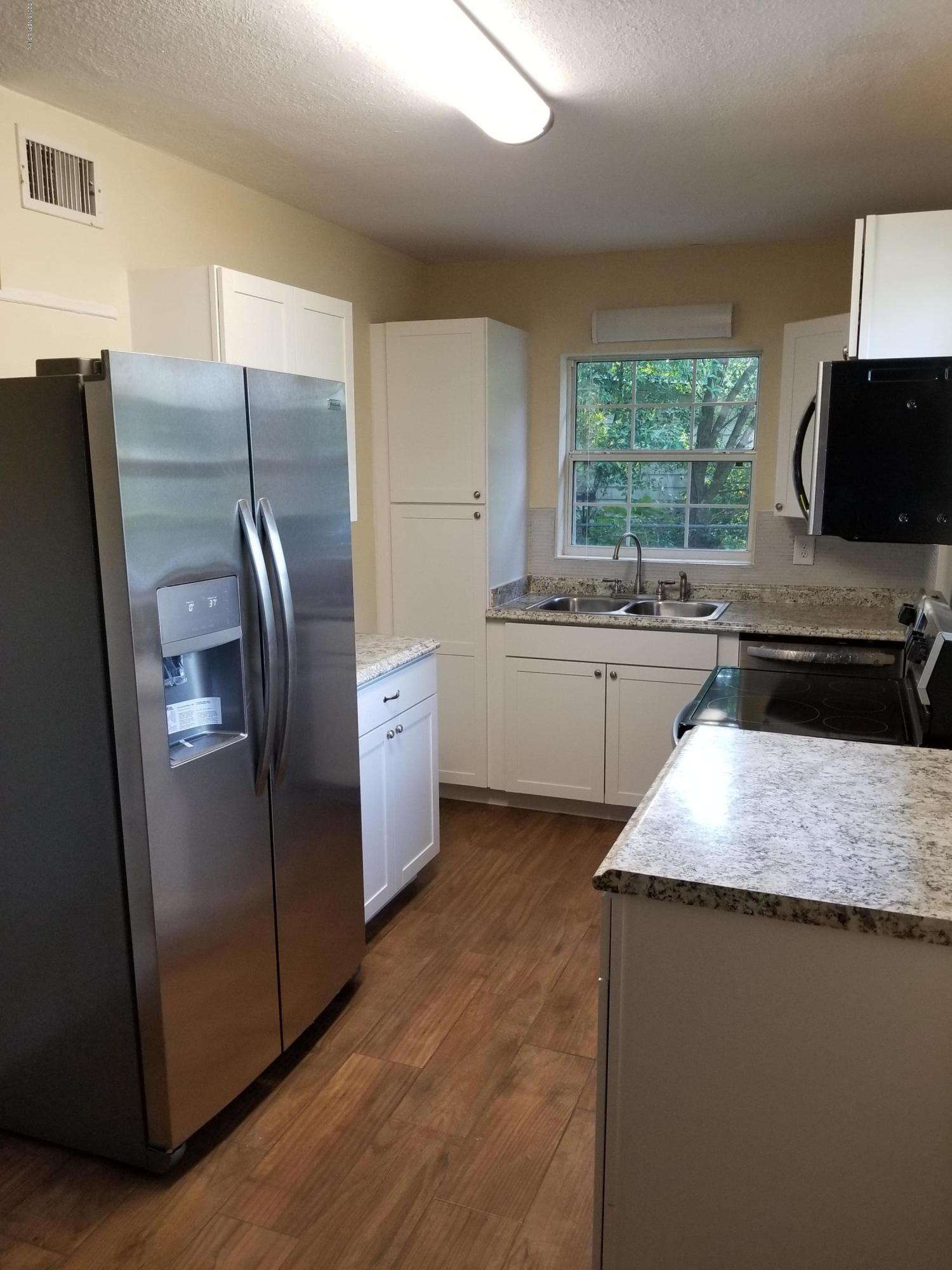 1847 Griflet Road Jacksonville, FL 32211 - Photo 11 of 32 a kitchen with stainless steel appliances granite countertop a refrigerator a sink a stove a microwave a counter space and cabinets