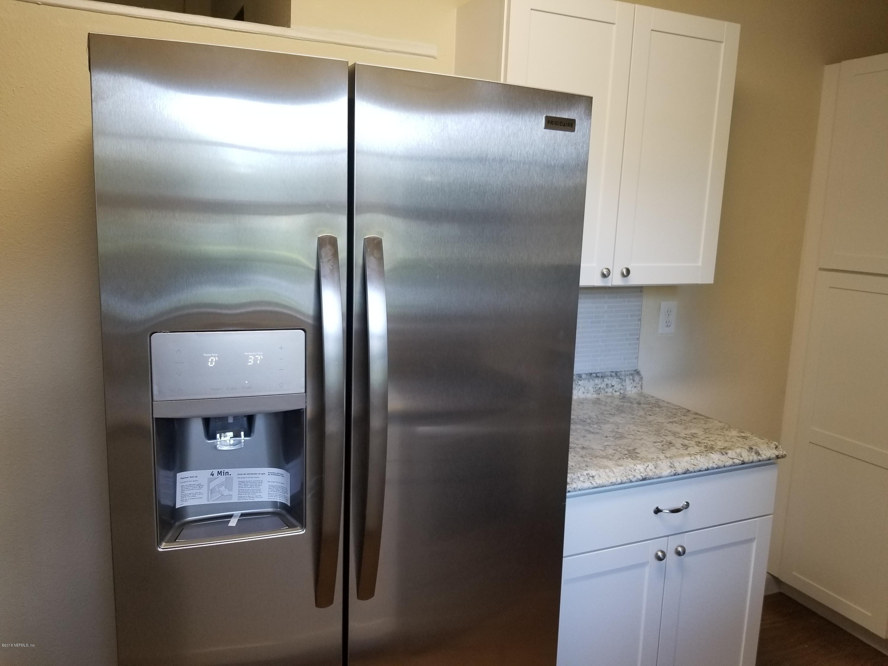 1847 Griflet Road Jacksonville, FL 32211 - Photo 12 of 32 a kitchen with a refrigerator and a sink