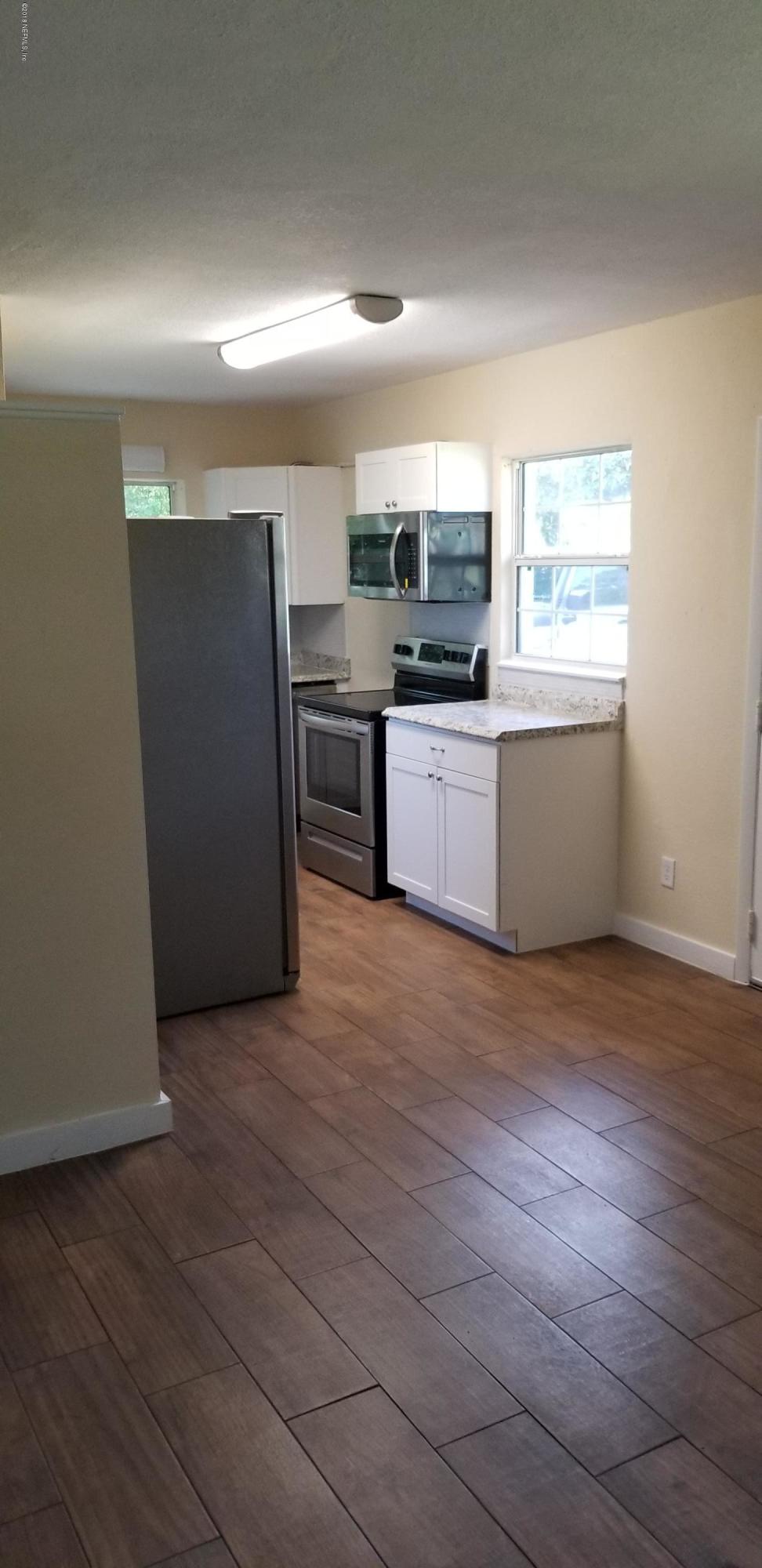1847 Griflet Road Jacksonville, FL 32211 - Photo 13 of 32 a kitchen with stainless steel appliances a refrigerator and a stove top oven