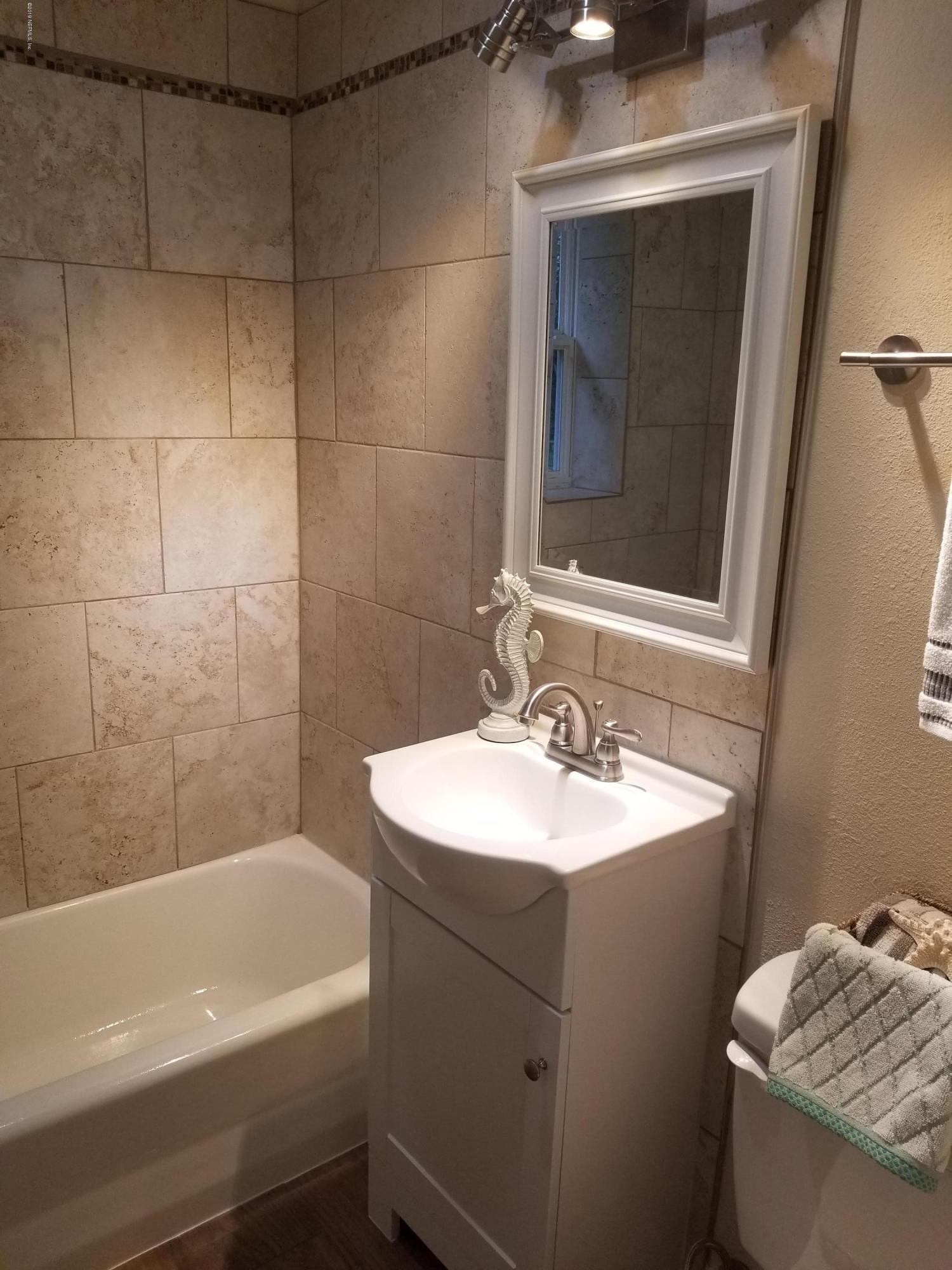 1847 Griflet Road Jacksonville, FL 32211 - Photo 16 of 32 a bathroom with a sink toilet and tub