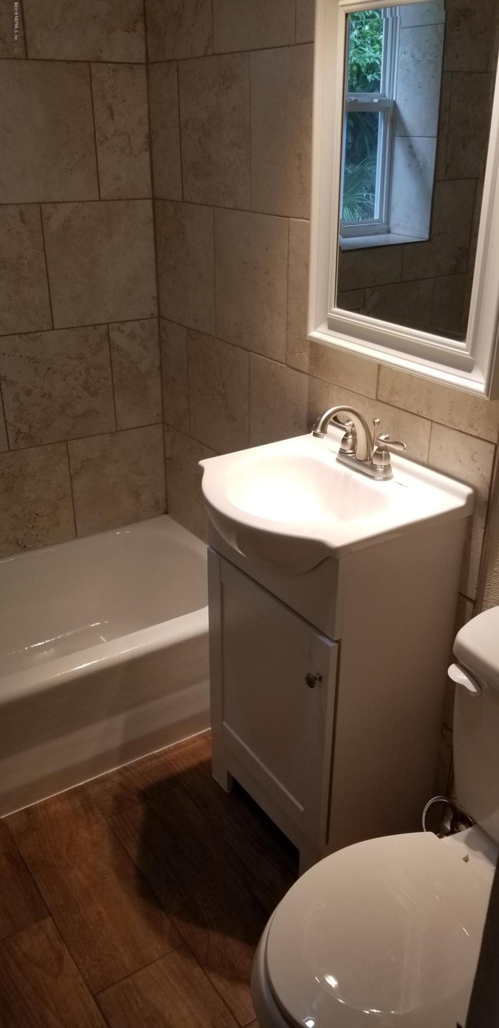 1847 Griflet Road Jacksonville, FL 32211 - Photo 17 of 32 a bathroom with a sink toilet vanity and bathtub