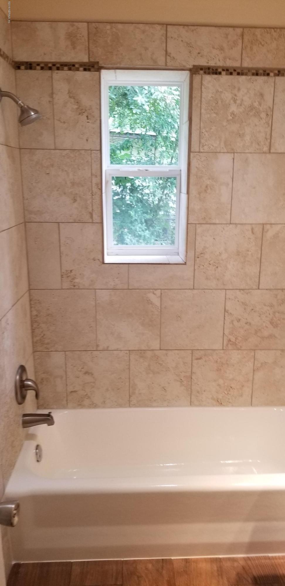 1847 Griflet Road Jacksonville, FL 32211 - Photo 18 of 32 a bathroom with a bathtub