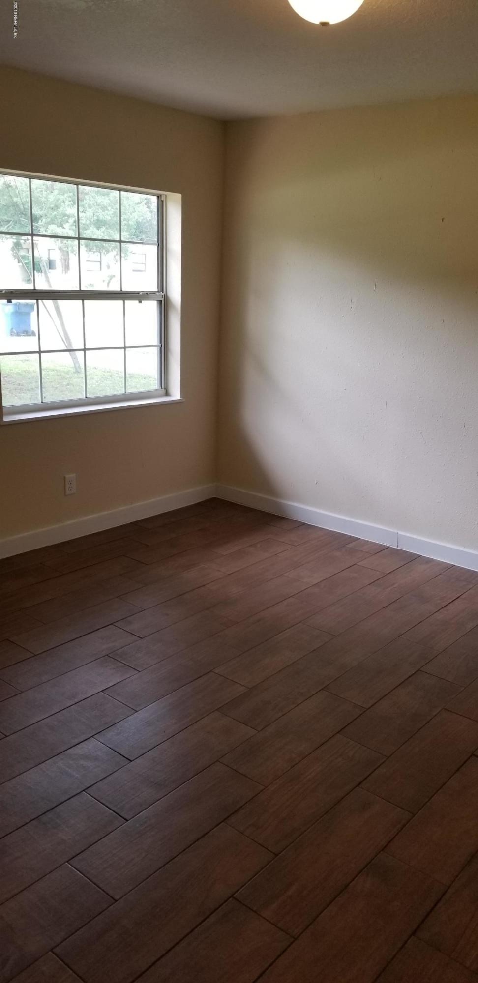 1847 Griflet Road Jacksonville, FL 32211 - Photo 21 of 32 wooden floor in an empty room with a window