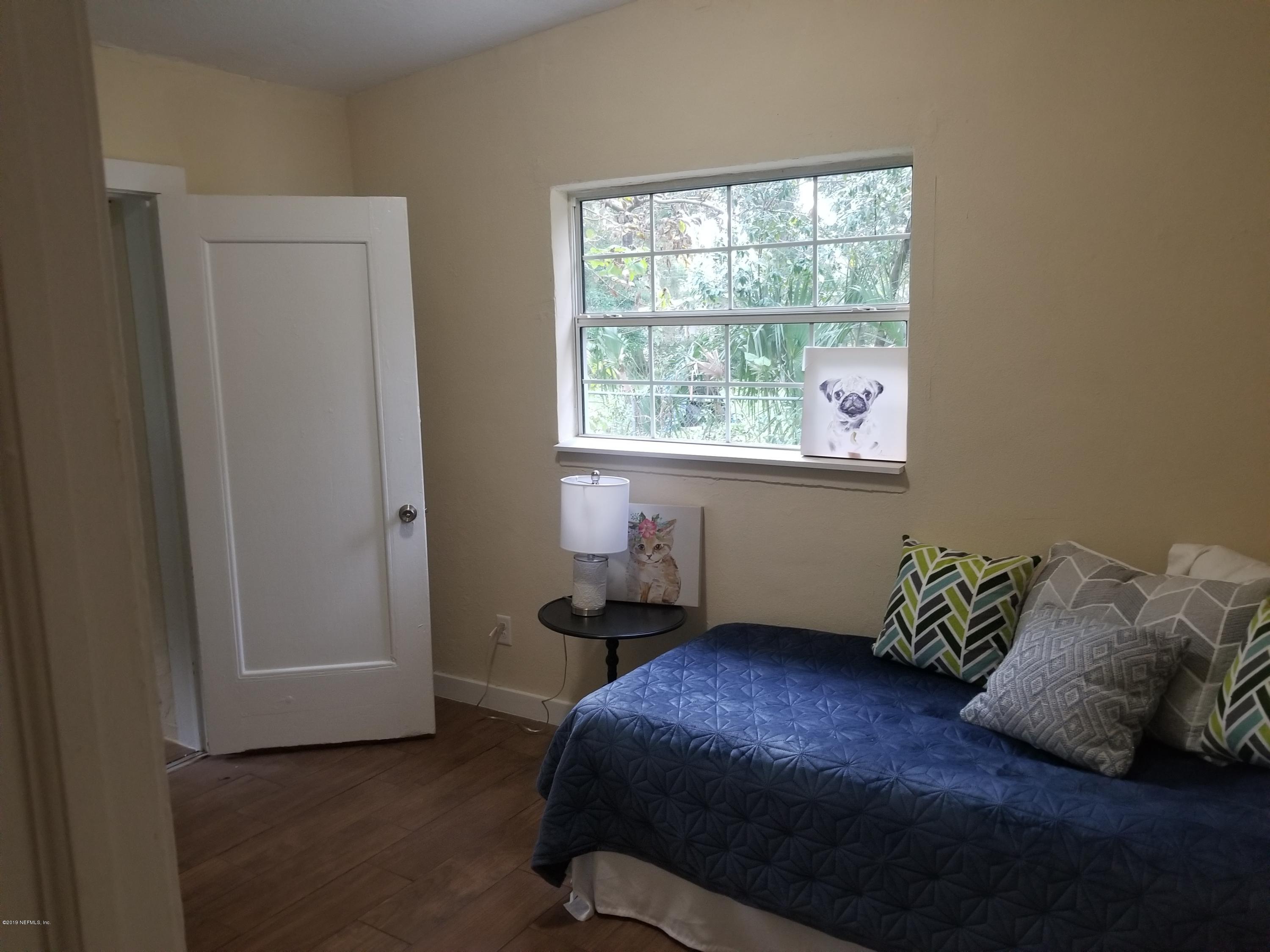 1847 Griflet Road Jacksonville, FL 32211 - Photo 23 of 32 a bedroom with a bed and a window