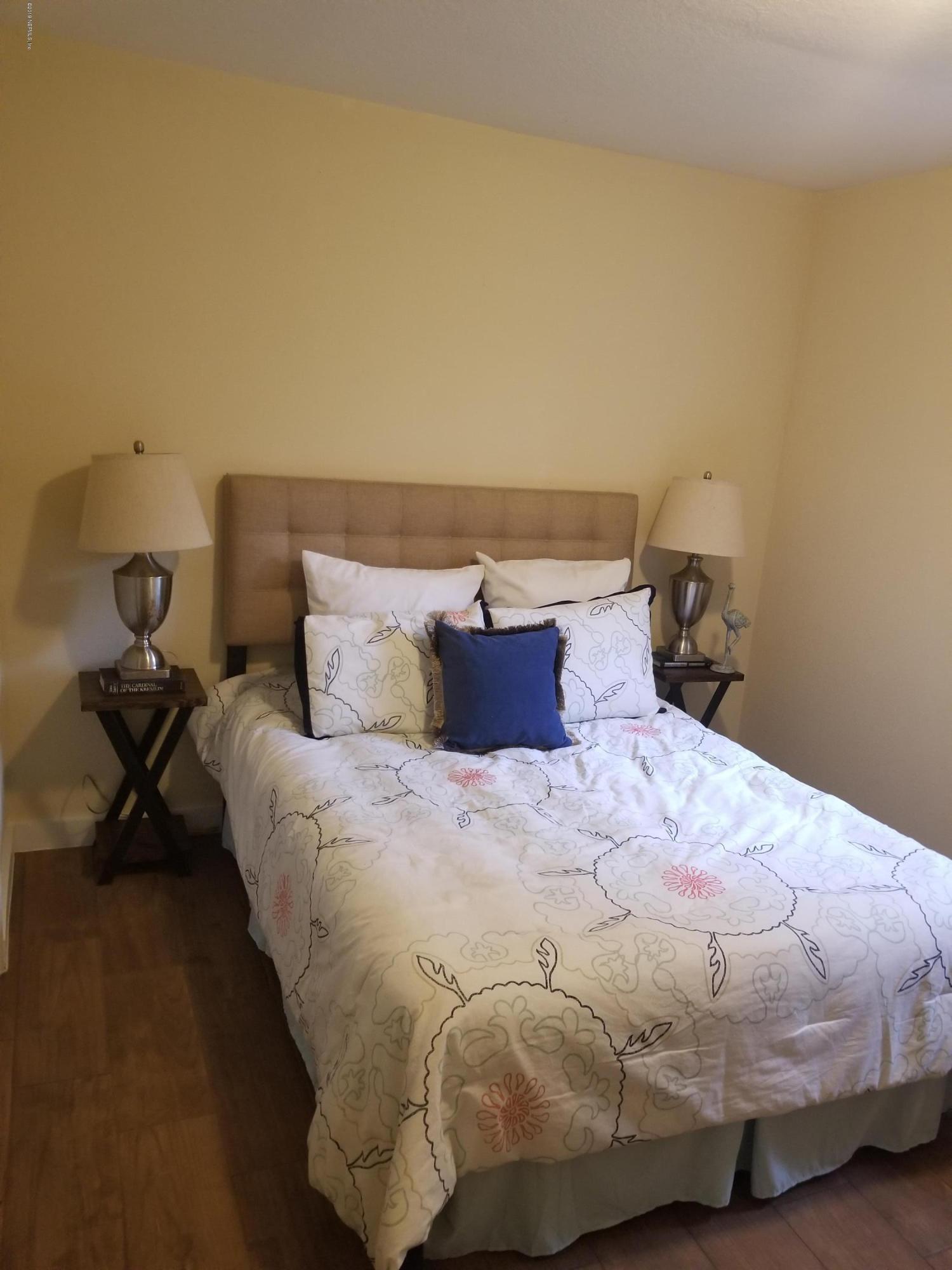 1847 Griflet Road Jacksonville, FL 32211 - Photo 29 of 32 a bedroom with a bed and wooden floor