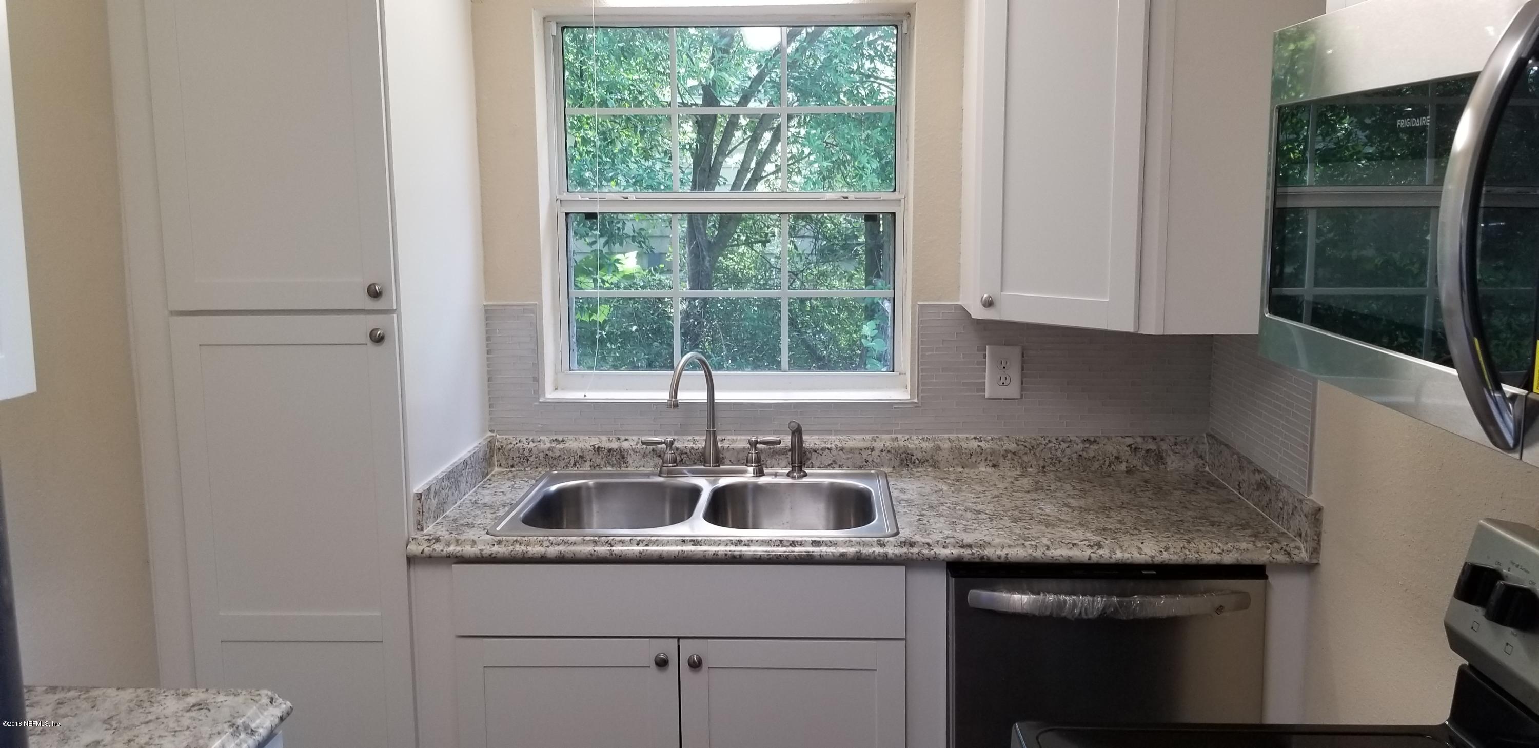 1847 Griflet Road Jacksonville, FL 32211 - Photo 6 of 32 a kitchen with a sink and cabinets