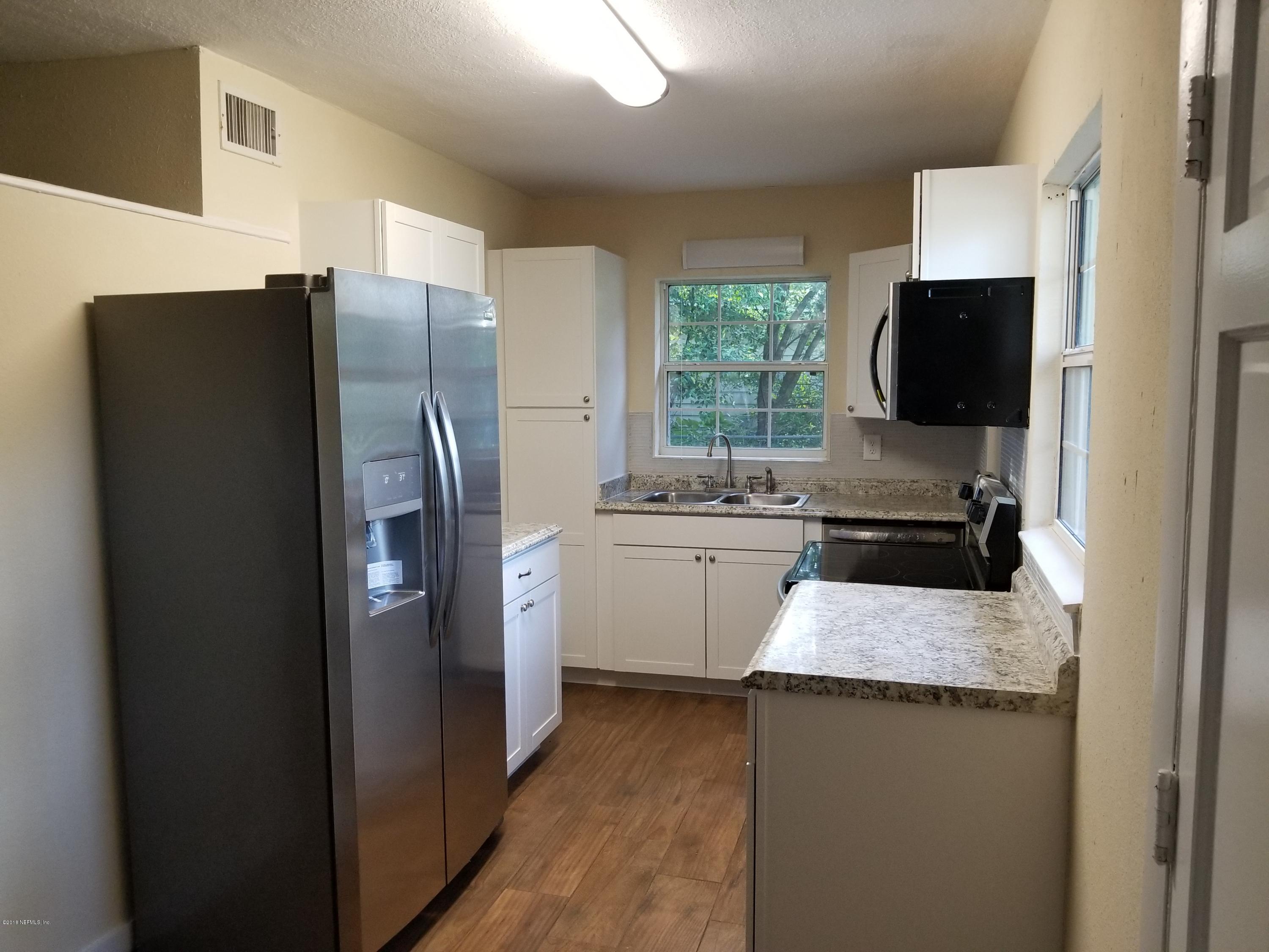 1847 Griflet Road Jacksonville, FL 32211 - Photo 7 of 32 a kitchen with a refrigerator and a sink