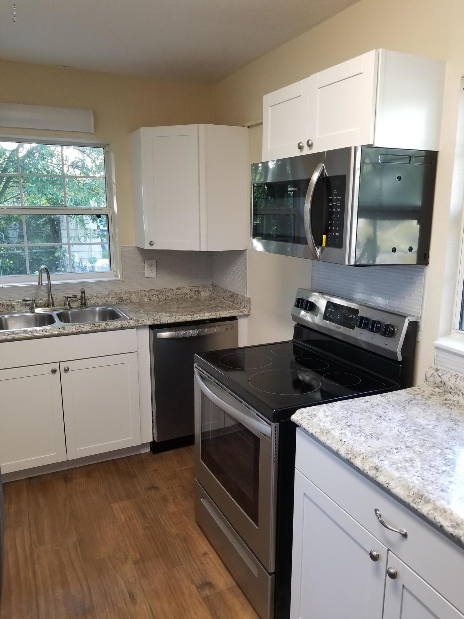 1847 Griflet Road Jacksonville, FL 32211 - Photo 8 of 32 a kitchen with a sink stove and microwave