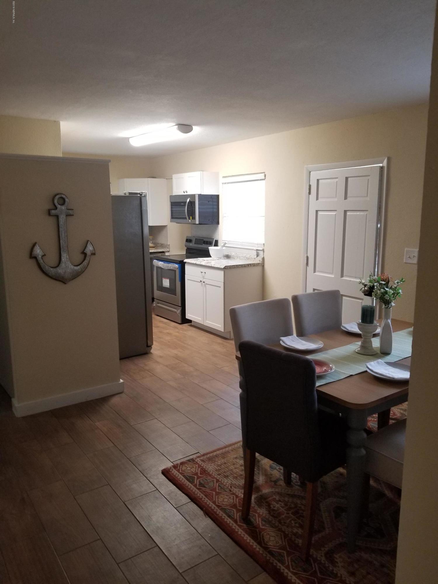 1847 Griflet Road Jacksonville, FL 32211 - Photo 10 of 32 a workspace with furniture and kitchen view