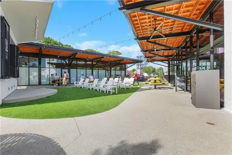 a view of a patio with a table and chairs under an umbrella