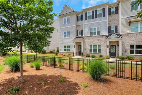 a front view of a house with a yard table and chairs