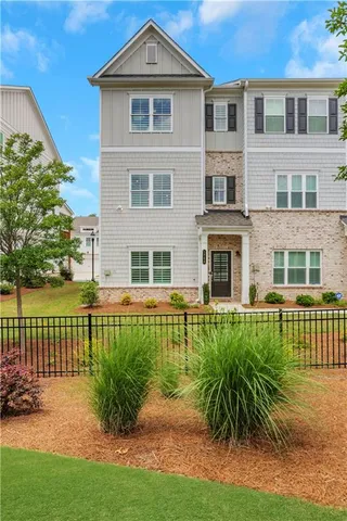 a front view of a house with a yard table and chairs
