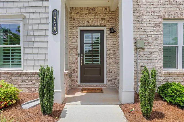 a front view of a house with a potted plant