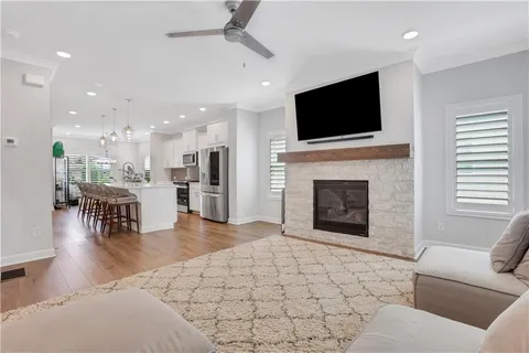 a living room with fireplace furniture and a flat screen tv