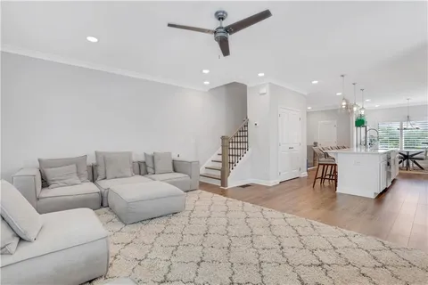 a living room with furniture and kitchen view