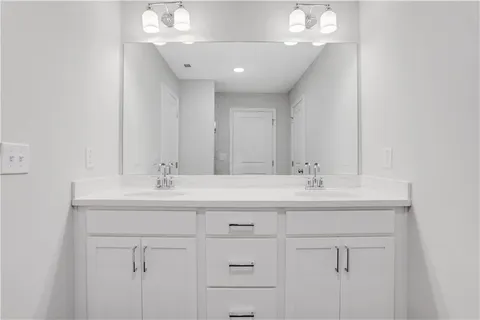 a bathroom with a sink double vanity and a mirror