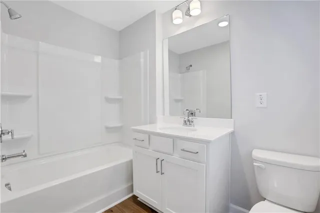 a bathroom with a sink a toilet and bathtub