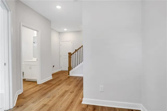 a view of a hallway with wooden floor