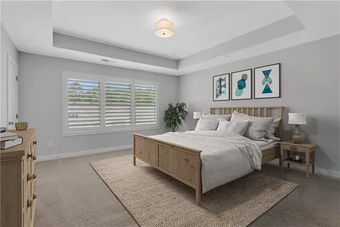 a spacious bedroom with a bed and a window