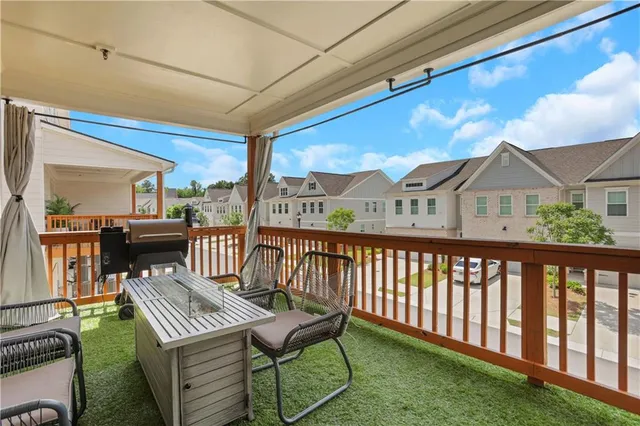 a view of a patio with table and chairs with wooden floor