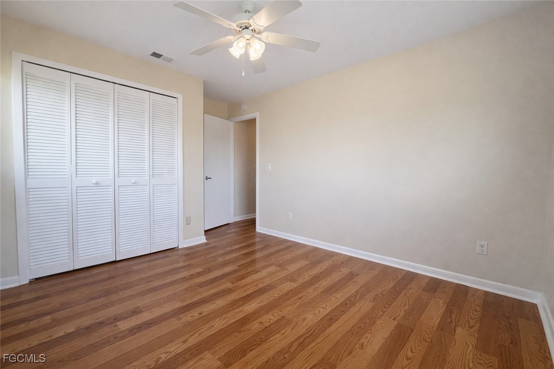 5014 26th Street Southwest Lehigh Acres, FL 33973 - Photo 12 of 20 a view of an empty room with wooden floor