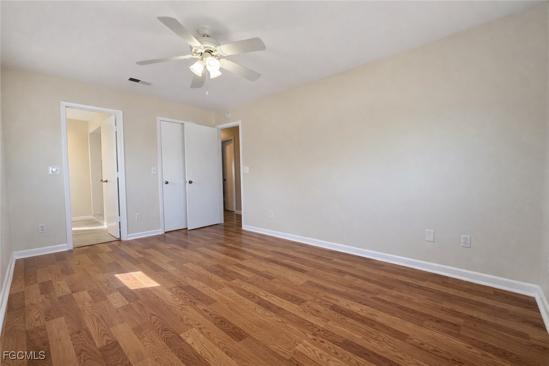 5014 26th Street Southwest Lehigh Acres, FL 33973 - Photo 16 of 20 a view of an empty room with wooden floor