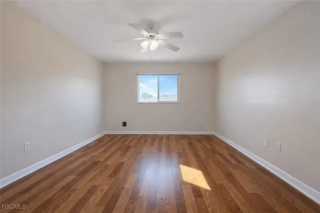 wooden floor in an empty room with a window