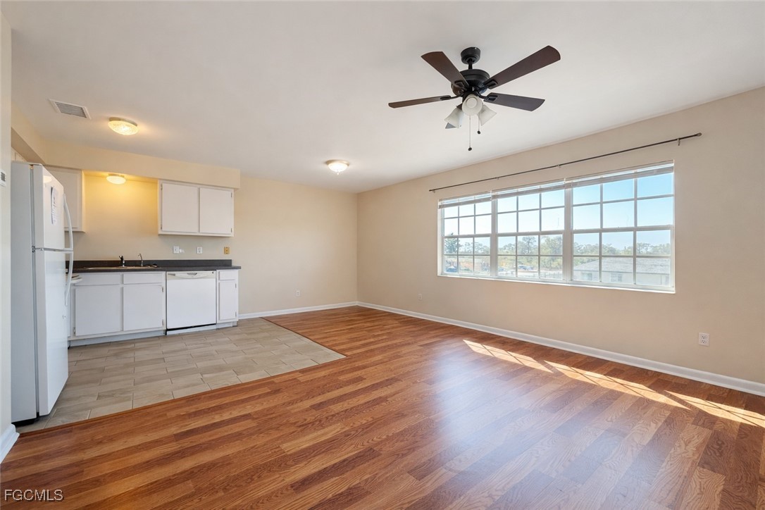 5014 26th Street Southwest Lehigh Acres, FL 33973 - Photo 2 of 20 a view of an empty room with window and wooden floor