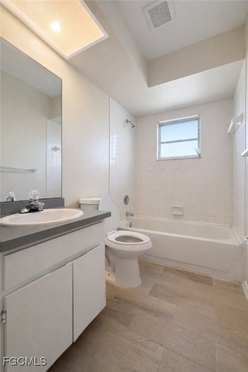 5014 26th Street Southwest Lehigh Acres, FL 33973 - Photo 9 of 20 a bathroom with a double vanity sink a toilet and a bathtub