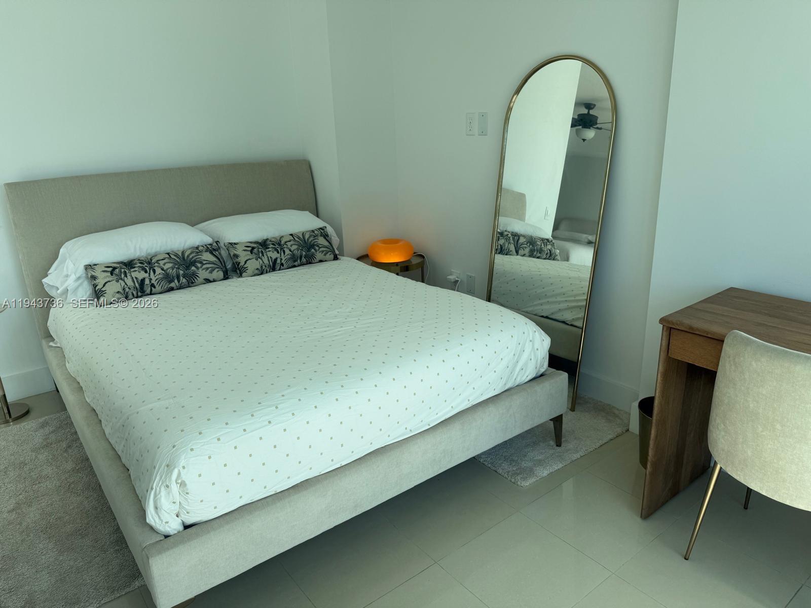 41 Southeast 5th Street, Unit 2010 Miami, FL 33131 - Photo 13 of 58 a bed sitting in a bedroom next to a window