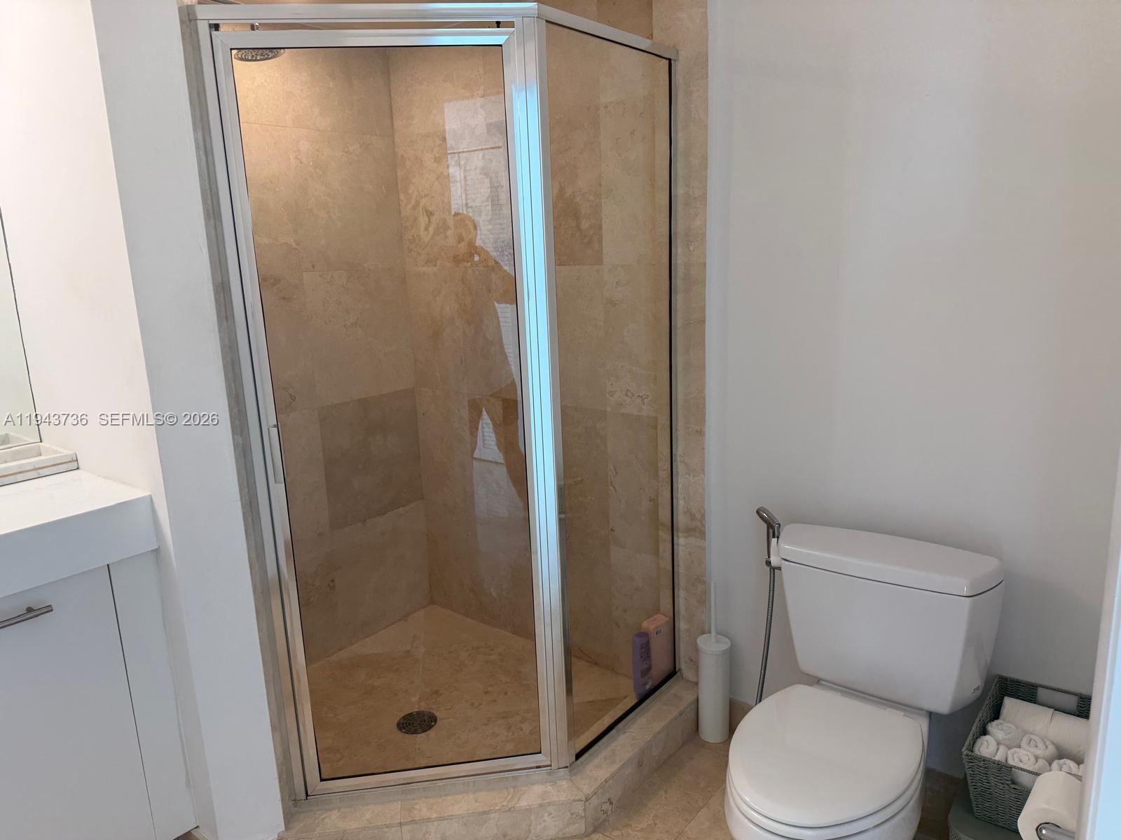 41 Southeast 5th Street, Unit 2010 Miami, FL 33131 - Photo 19 of 58 a bathroom with a shower and toilet