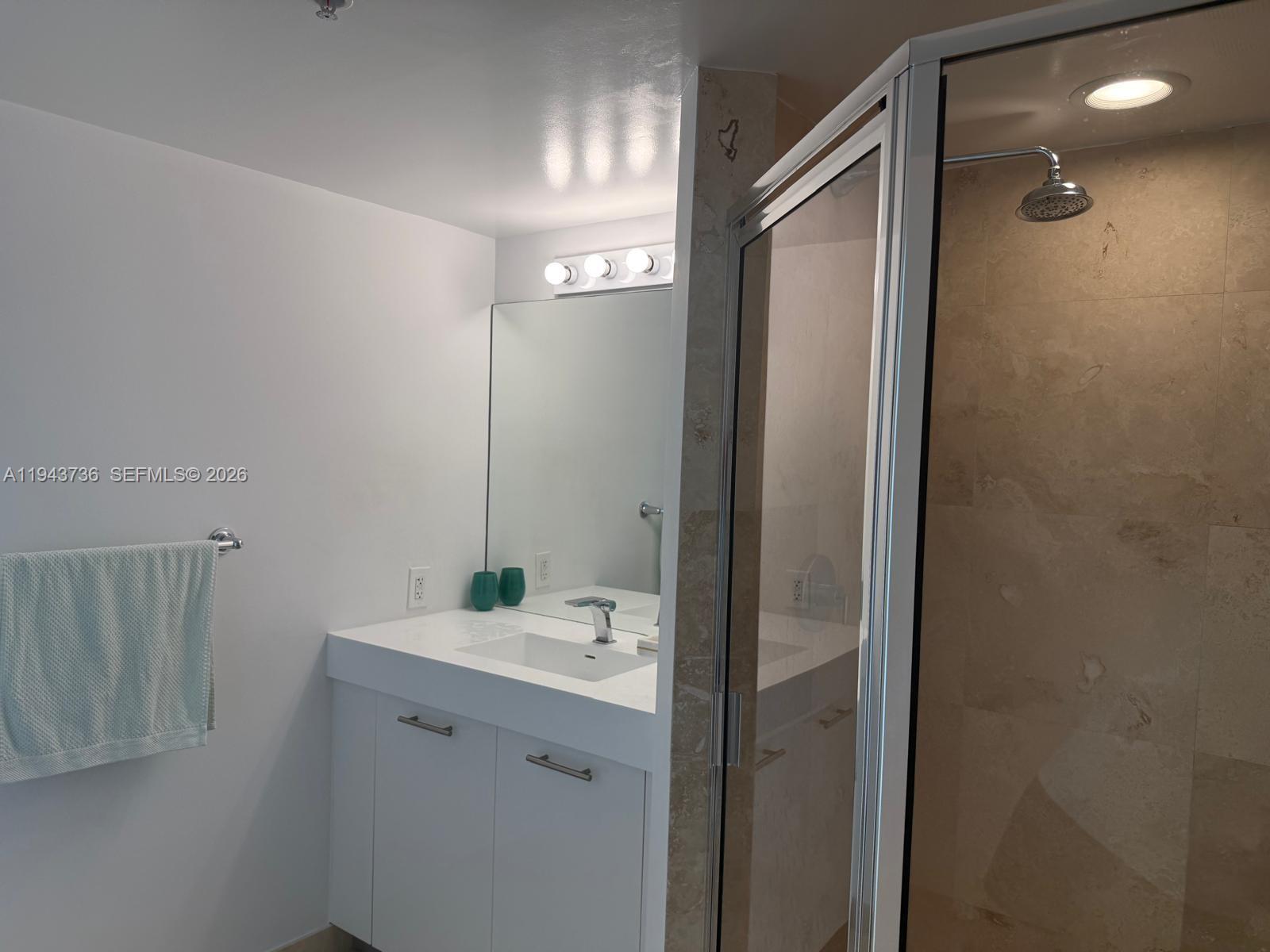 41 Southeast 5th Street, Unit 2010 Miami, FL 33131 - Photo 20 of 58 a bathroom with a mirror and a shower