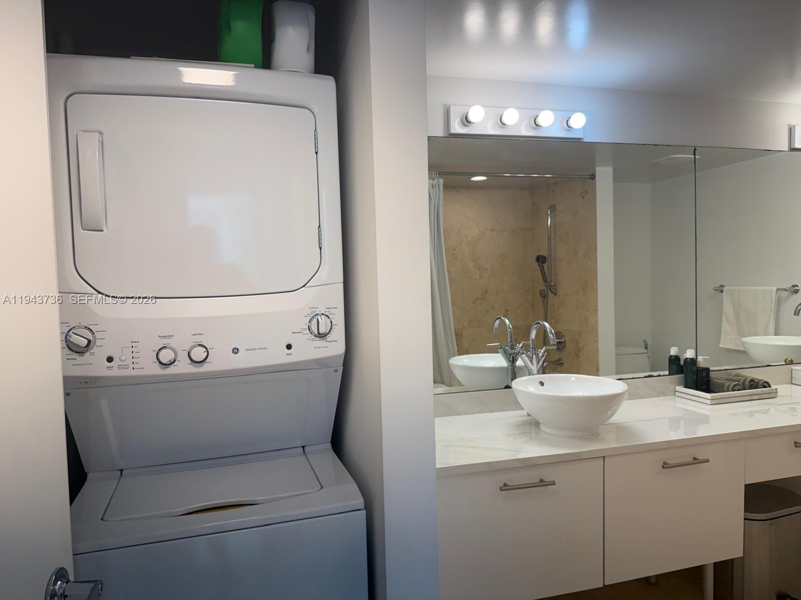 41 Southeast 5th Street, Unit 2010 Miami, FL 33131 - Photo 23 of 58 a bathroom with a sink mirror and toilet