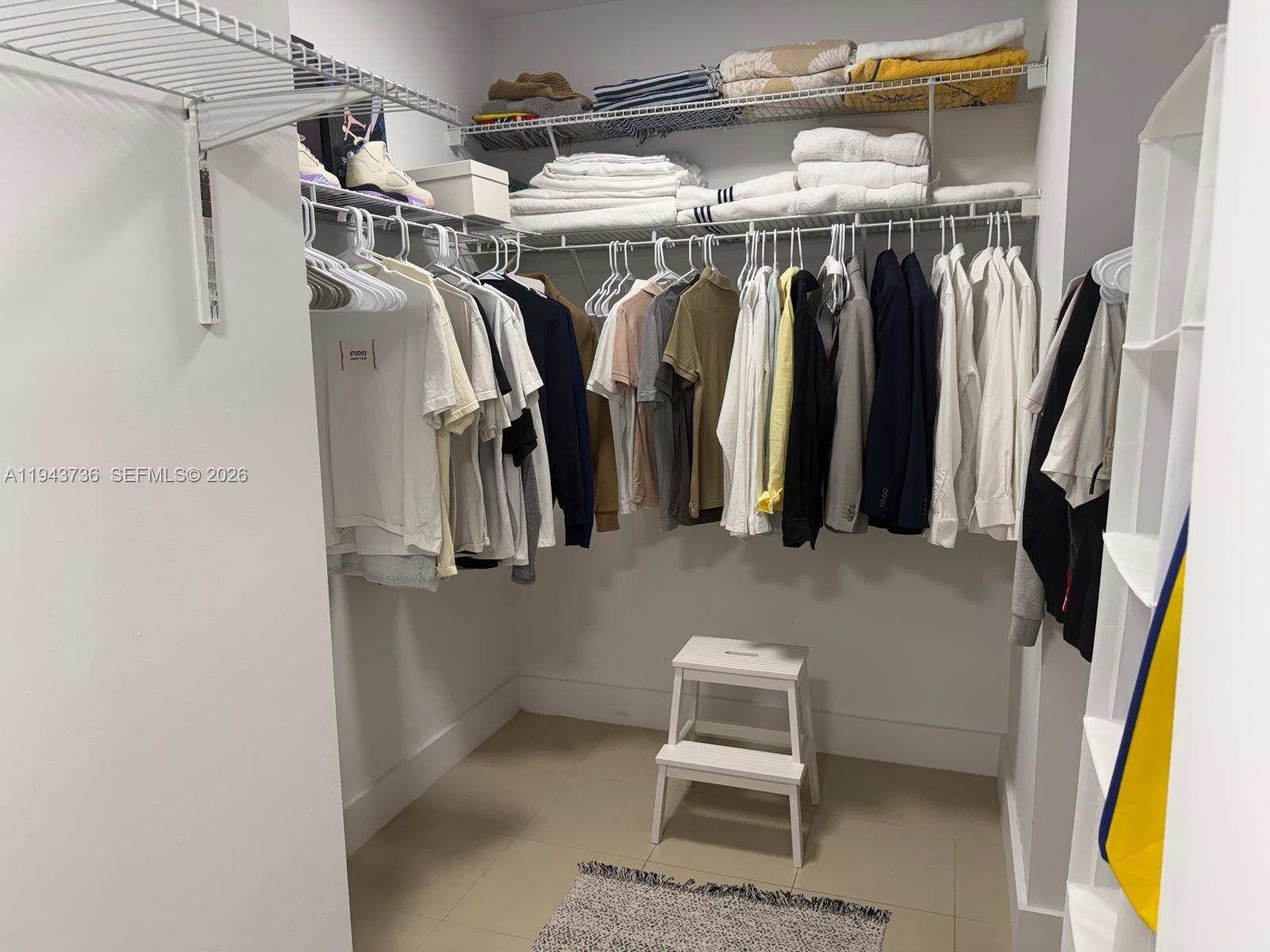 41 Southeast 5th Street, Unit 2010 Miami, FL 33131 - Photo 30 of 58 a view of walk in closet with clothes and shoes