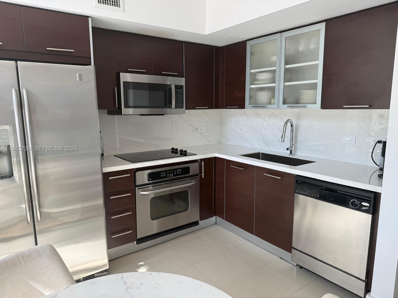 41 Southeast 5th Street, Unit 2010 Miami, FL 33131 - Photo 33 of 58 a kitchen with a sink and stainless steel appliances