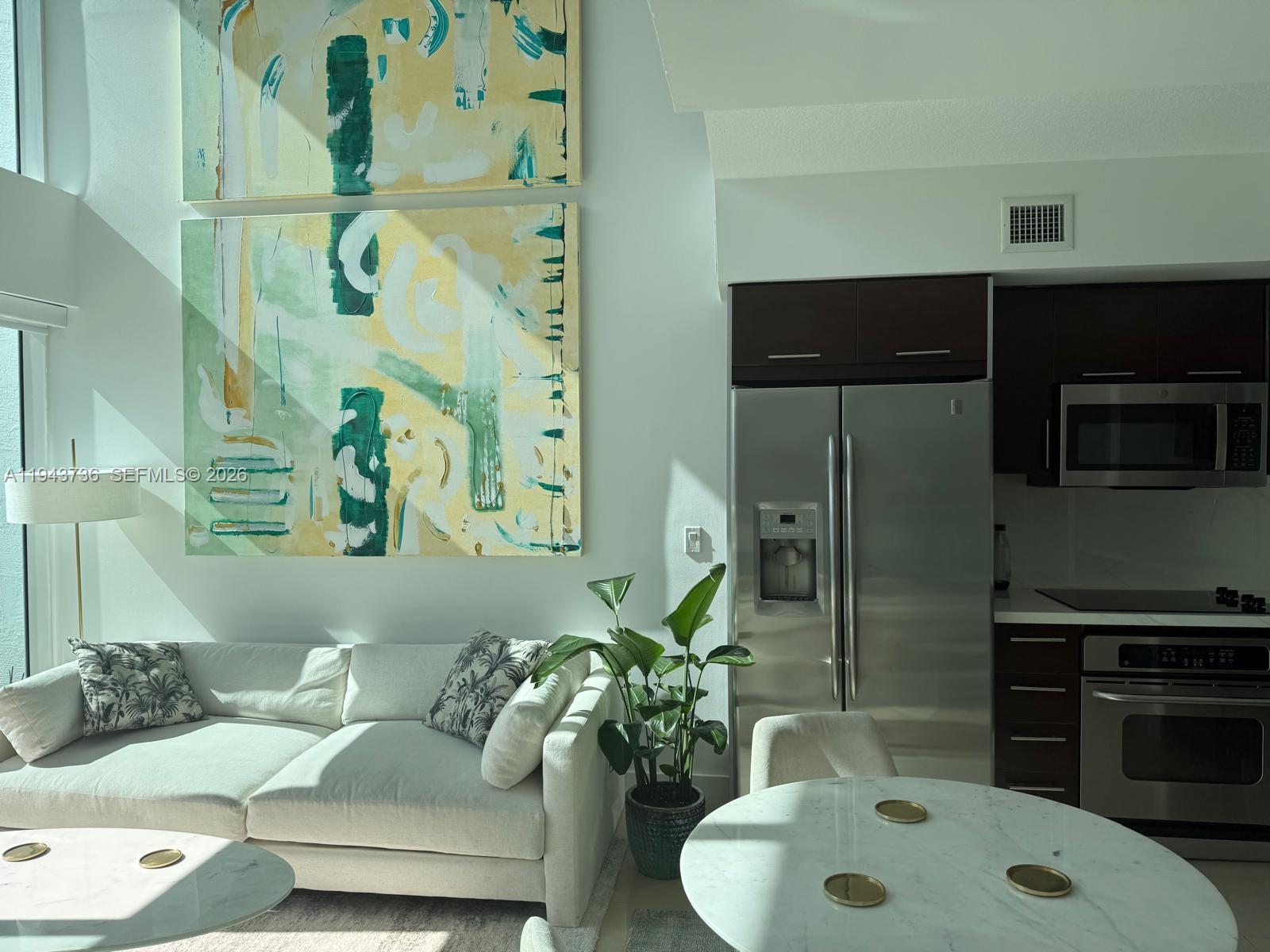 41 Southeast 5th Street, Unit 2010 Miami, FL 33131 - Photo 38 of 58 a living room with furniture and a fireplace