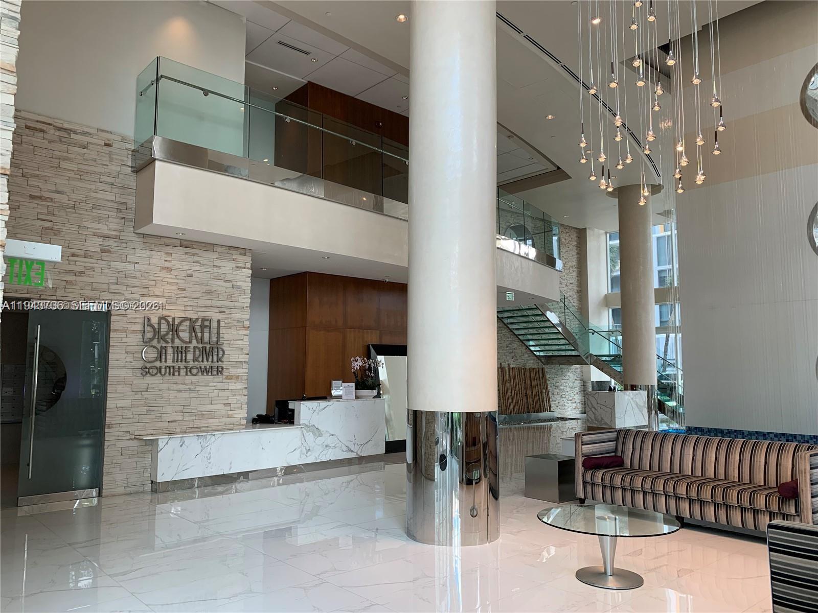 41 Southeast 5th Street, Unit 2010 Miami, FL 33131 - Photo 49 of 58 a living room with furniture and a fireplace