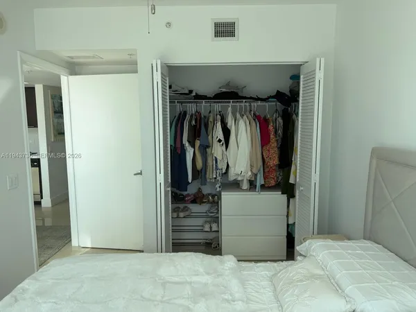 a bed sitting in a room next to a window