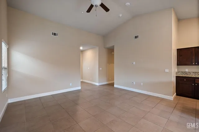 an empty room with projector and a fireplace